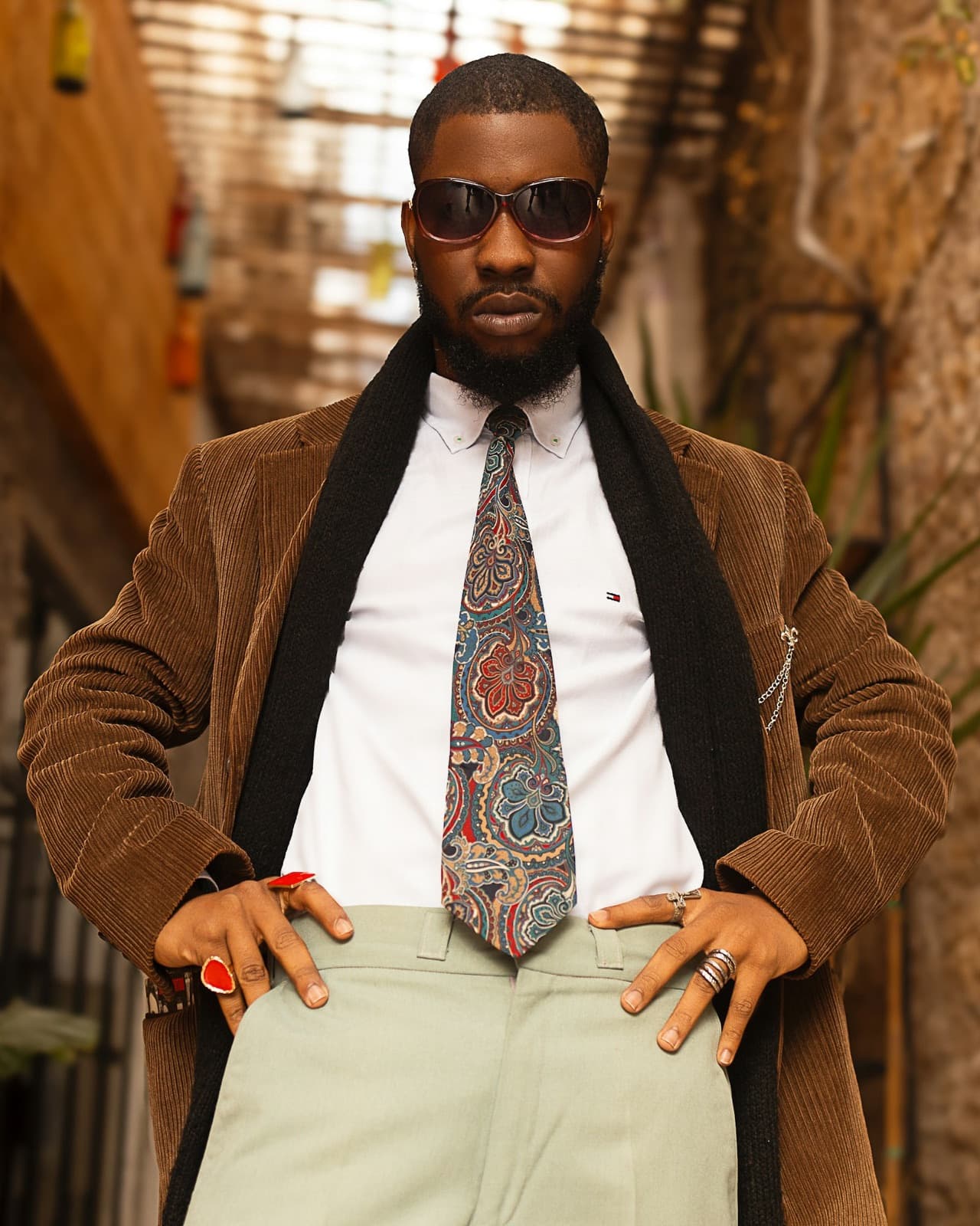 A man in a corduroy jacket and sunglasses